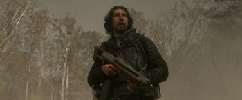 Movie still from “65” (2023), directed by Bryan Woods – A man holding a gun while standing in the fog; Medium shot, Low angle