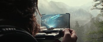 Movie still from “65” (2023), directed by Bryan Woods – A woman sitting in front of a computer screen; Extreme Close Up shot, High angle