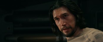 Movie still from “65” (2023), directed by Bryan Woods – A person with long black hair; Close Up shot, Over the shoulder angle