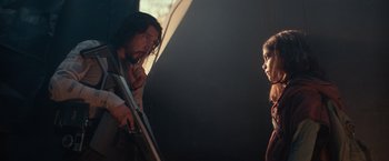 Movie still from “65” (2023), directed by Bryan Woods – A man and a woman standing next to each other; Medium shot, Over the shoulder angle