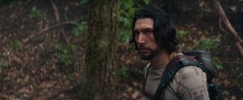 Movie still from “65” (2023), directed by Bryan Woods – A person with a tree in the background; Close Up shot, Over the shoulder angle