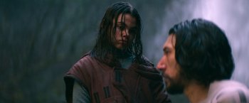 Movie still from “65” (2023), directed by Bryan Woods – A man and a woman standing next to each other; Close Up shot, Over the shoulder angle