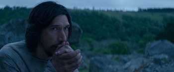 Movie still from “65” (2023), directed by Bryan Woods – A person holding their hands to their mouth; Close Up shot, High angle