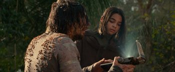 Movie still from “65” (2023), directed by Bryan Woods – A man and a woman looking at a cell phone; Close Up shot, Low angle