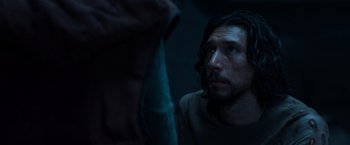 Movie still from “65” (2023), directed by Bryan Woods – A person with long dark hair; Close Up shot, Over the shoulder angle