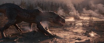 Movie still from “65” (2023), directed by Bryan Woods – An image of a t - rex in the middle of the day; Extreme Wide shot, High angle