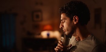 A person holding a glass of water