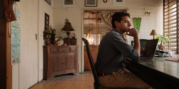 A man sitting at a table in a room