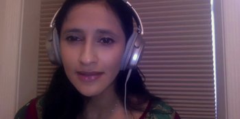 Movie still from “7 Days” (2021), directed by Roshan Sethi – A woman wearing a pair of white headphones; Close Up shot, High angle