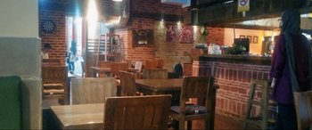 Movie still from “752 Is Not a Number” (2022), directed by Babak Payami – A room with a lot of wooden furniture in it; Extreme Wide shot, High angle