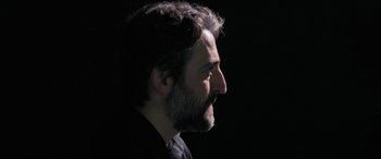 Movie still from “752 Is Not a Number” (2022), directed by Babak Payami – A person with a beard; Close Up shot, Low angle