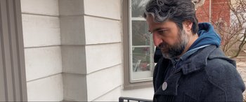 Movie still from “752 Is Not a Number” (2022), directed by Babak Payami – A person talking on a cell phone; Close Up shot, Over the shoulder angle