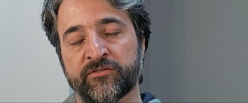 Movie still from “752 Is Not a Number” (2022), directed by Babak Payami – A person with his eyes closed; Extreme Close Up shot, Over the shoulder angle