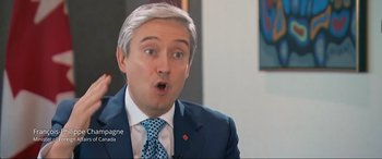 Movie still from “752 Is Not a Number” (2022), directed by Babak Payami – A person wearing a suit and tie; Close Up shot, Over the shoulder angle