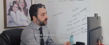 Movie still from “752 Is Not a Number” (2022), directed by Babak Payami – An image of a man sitting in front of a whiteboard; Medium shot, Over the shoulder angle