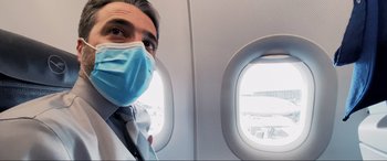 Movie still from “752 Is Not a Number” (2022), directed by Babak Payami – A man wearing a face mask on an airplane; Close Up shot, Low angle