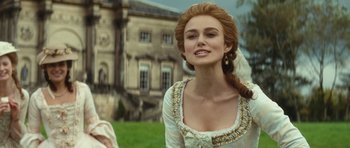 Movie still from “The Duchess” (2008), directed by Saul Dibb – A woman in a white dress with a long braid; Close Up shot, Over the shoulder angle