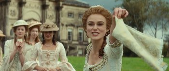 Movie still from “The Duchess” (2008), directed by Saul Dibb – Two women in period dress in front of an old mansion; Medium shot, Over the shoulder angle