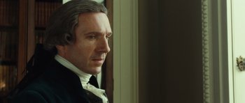 Movie still from “The Duchess” (2008), directed by Saul Dibb – A person wearing a suit and bow tie; Close Up shot, Over the shoulder angle