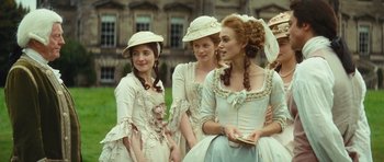 Movie still from “The Duchess” (2008), directed by Saul Dibb – A group of young girls dressed in period clothing; Medium shot, Over the shoulder angle