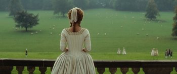 Movie still from “The Duchess” (2008), directed by Saul Dibb – A woman dressed in period clothing looking out over a field; Wide shot, Over the shoulder angle