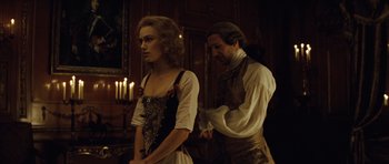 Movie still from “The Duchess” (2008), directed by Saul Dibb – A man and a woman standing next to each other in front of candles; Medium shot, Over the shoulder angle