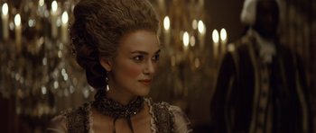 Movie still from “The Duchess” (2008), directed by Saul Dibb – A woman in a dress and a necklace; Close Up shot, Over the shoulder angle