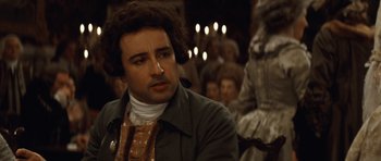 Movie still from “The Duchess” (2008), directed by Saul Dibb – A man in a brown jacket sitting in front of a group of people; Close Up shot, Over the shoulder angle