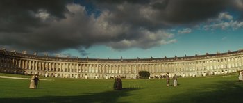 Movie still from “The Duchess” (2008), directed by Saul Dibb – People are standing in the grass in front of a large building; Extreme Wide shot, High angle
