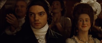 Movie still from “The Duchess” (2008), directed by Saul Dibb – A person wearing a suit and tie; Close Up shot, Over the shoulder angle