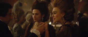 Movie still from “The Duchess” (2008), directed by Saul Dibb – Two women in period dress looking at each other; Close Up shot, Over the shoulder angle