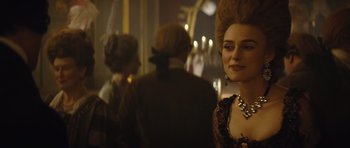 Movie still from “The Duchess” (2008), directed by Saul Dibb – A person wearing a dress and a necklace; Close Up shot, Over the shoulder angle