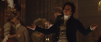 Movie still from “The Duchess” (2008), directed by Saul Dibb – A man in a suit and a wig is holding his hand out; Medium shot, Low angle
