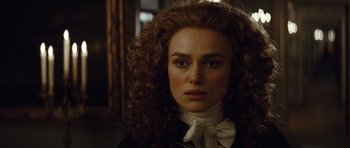 Movie still from “The Duchess” (2008), directed by Saul Dibb – A person with curly red hair; Close Up shot, Over the shoulder angle