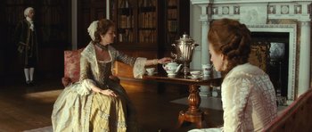 Movie still from “The Duchess” (2008), directed by Saul Dibb – Two women sitting at a table with a tea pot and cups; Medium shot, High angle
