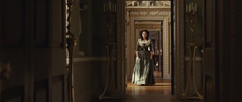 Movie still from “The Duchess” (2008), directed by Saul Dibb – A woman in a long dress standing in a hallway; Wide shot, Low angle