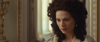 Movie still from “The Duchess” (2008), directed by Saul Dibb – A person with long curly hair; Close Up shot, Over the shoulder angle