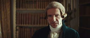 Movie still from “The Duchess” (2008), directed by Saul Dibb – A person wearing a suit and tie; Close Up shot, Low angle