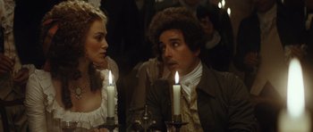 Movie still from “The Duchess” (2008), directed by Saul Dibb – A man and a woman sitting at a table with lit candles in front of them; Close Up shot, Over the shoulder angle