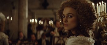 Movie still from “The Duchess” (2008), directed by Saul Dibb – A person with curly hair; Close Up shot, Over the shoulder angle