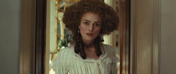 Movie still from “The Duchess” (2008), directed by Saul Dibb – A woman in a white dress with long brown hair; Close Up shot, Over the shoulder angle