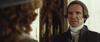 Movie still from “The Duchess” (2008), directed by Saul Dibb – A person wearing a suit and tie; Close Up shot, Over the shoulder angle