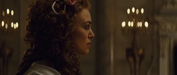 Movie still from “The Duchess” (2008), directed by Saul Dibb – A person with curly hair; Close Up shot, Over the shoulder angle