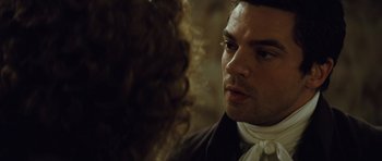 Movie still from “The Duchess” (2008), directed by Saul Dibb – A person wearing a suit and tie; Close Up shot, Over the shoulder angle