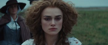 Movie still from “The Duchess” (2008), directed by Saul Dibb – A person with long curly hair; Close Up shot, Over the shoulder angle