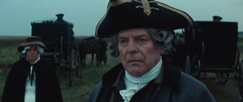 Movie still from “The Duchess” (2008), directed by Saul Dibb – A man in a pirate hat standing in front of horses; Close Up shot, Over the shoulder angle