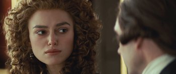 Movie still from “The Duchess” (2008), directed by Saul Dibb – A person with curly hair; Close Up shot, Over the shoulder angle