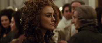 Movie still from “The Duchess” (2008), directed by Saul Dibb – A person with curly hair; Close Up shot, Over the shoulder angle