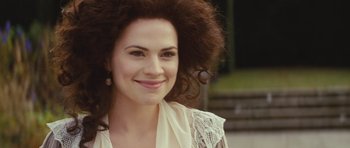 Movie still from “The Duchess” (2008), directed by Saul Dibb – A beautiful woman with long brown hair smiling for the camera; Close Up shot, Over the shoulder angle