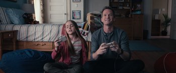 A man and a girl are playing a video game together